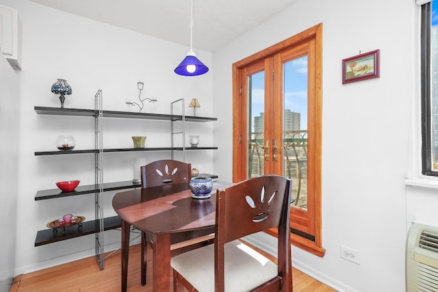 dining room with french doors and light wood-type flooring