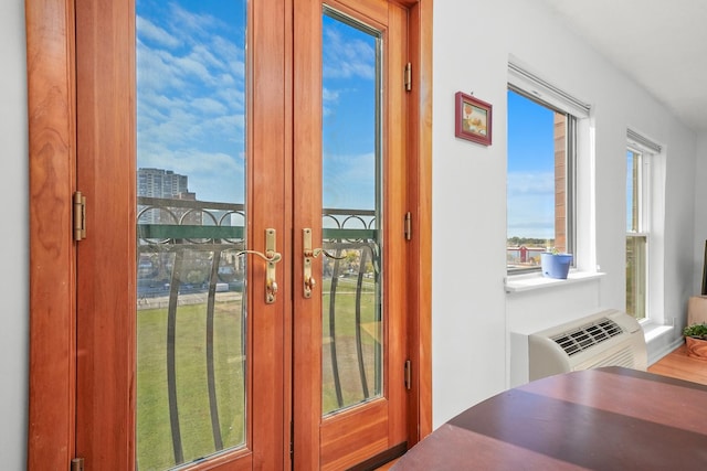 doorway featuring french doors and a wall unit AC