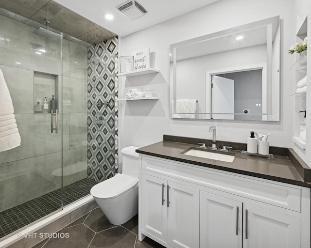 bathroom with vanity, tile patterned flooring, a shower with shower door, and toilet