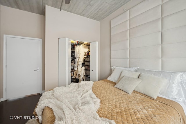 bedroom with a walk in closet and a closet