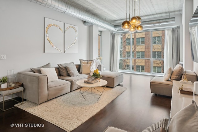 living room featuring wood-type flooring and a notable chandelier