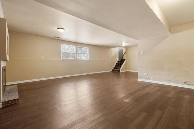 unfurnished living room with dark wood-type flooring