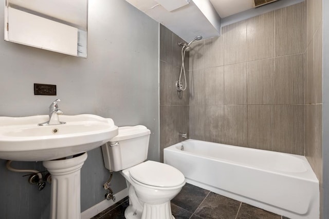 bathroom featuring toilet and tiled shower / bath combo