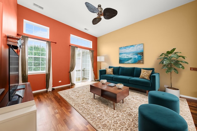 living room featuring ceiling fan and dark hardwood / wood-style floors