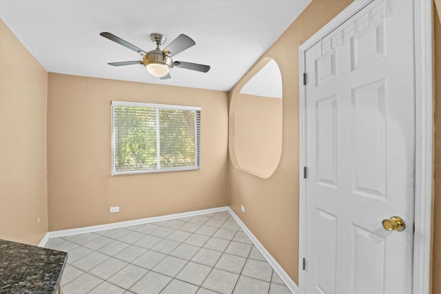 spare room featuring ceiling fan and light tile patterned floors