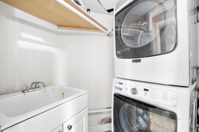 clothes washing area with sink and stacked washer / dryer