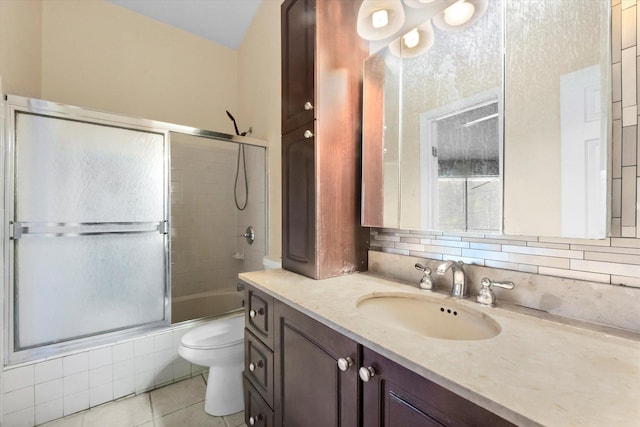 full bathroom featuring bath / shower combo with glass door, tile patterned flooring, decorative backsplash, and vanity