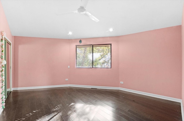 unfurnished room with ceiling fan and dark wood-type flooring