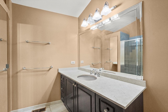 bathroom with vanity, an enclosed shower, and tile patterned flooring