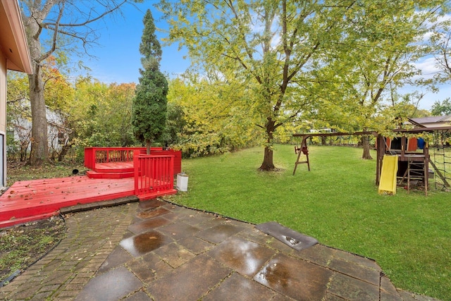 view of yard with a patio and a wooden deck