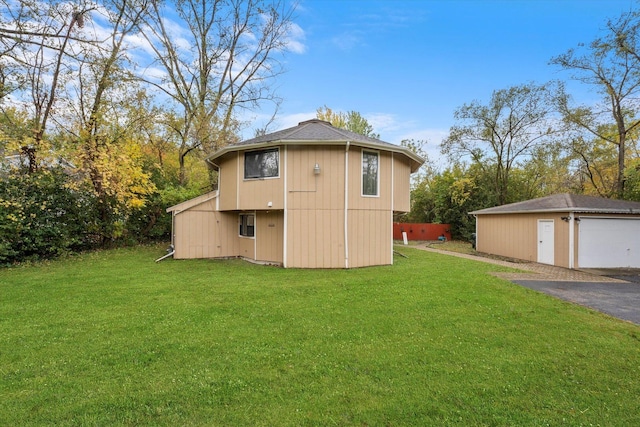 view of outbuilding featuring a yard and a garage