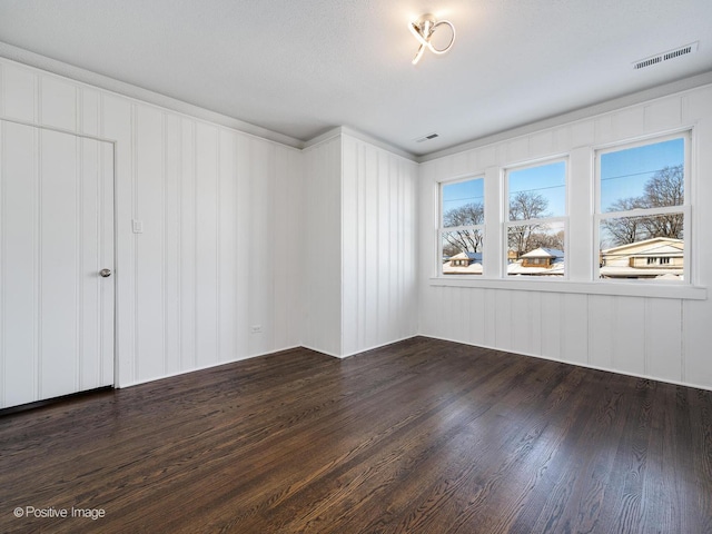 unfurnished room featuring dark wood-type flooring