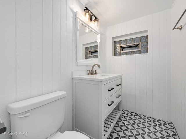 bathroom featuring toilet and vanity