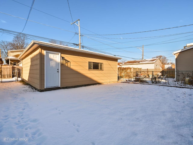 view of snow covered rear of property