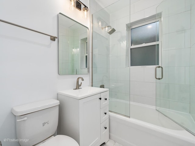 full bathroom featuring vanity, shower / bath combination with glass door, and toilet