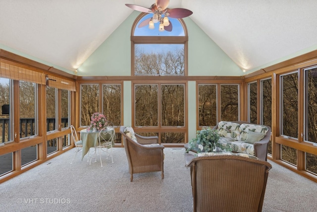 sunroom featuring lofted ceiling, a wealth of natural light, and ceiling fan