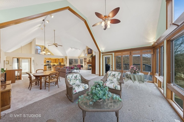 living room with high vaulted ceiling, light colored carpet, and ceiling fan