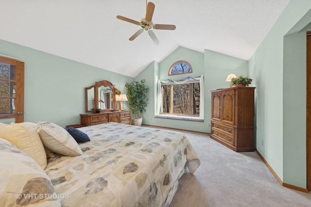 bedroom featuring vaulted ceiling, light carpet, and ceiling fan