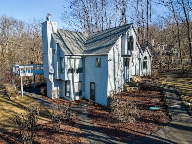 view of side of property featuring a wooden deck