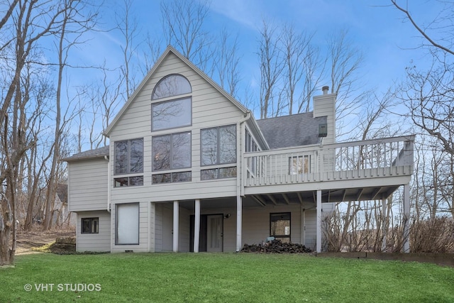 rear view of house with a wooden deck and a yard