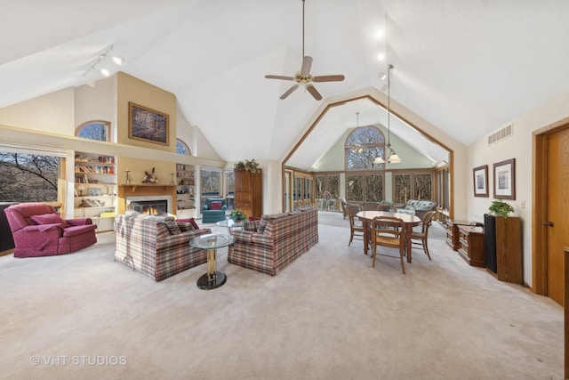 living room featuring lofted ceiling, ceiling fan, and carpet flooring