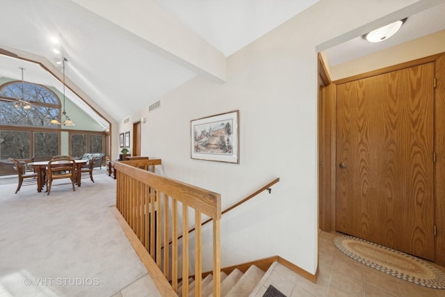 interior space featuring carpet and vaulted ceiling with beams