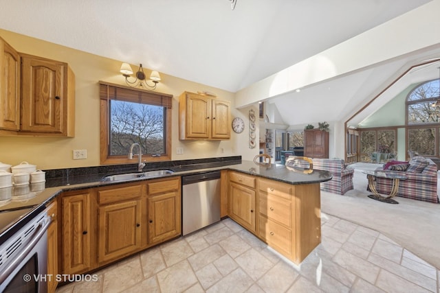 kitchen featuring sink, vaulted ceiling with beams, dark stone countertops, kitchen peninsula, and stainless steel appliances