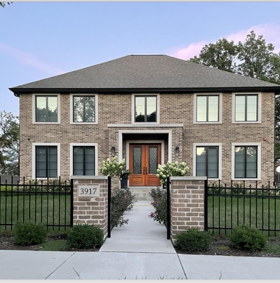 view of front of property with french doors and a yard