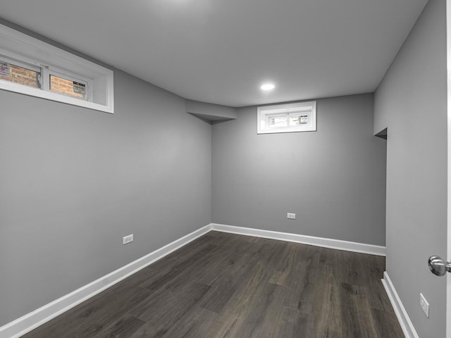 basement with dark hardwood / wood-style flooring