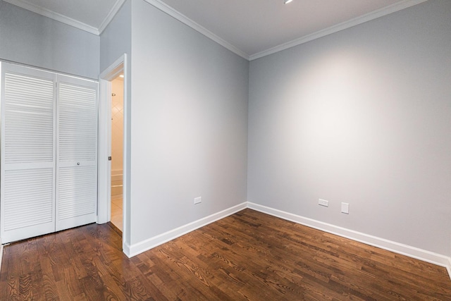 interior space with dark hardwood / wood-style flooring, a closet, and crown molding