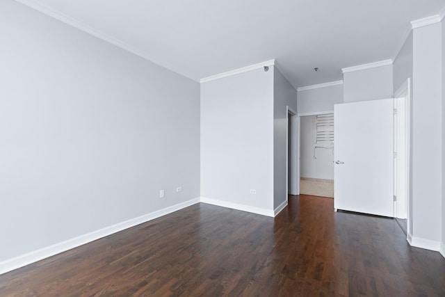 spare room with dark wood-type flooring and crown molding