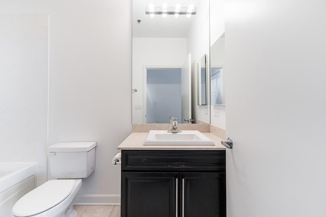 bathroom featuring tile patterned floors, vanity, and toilet