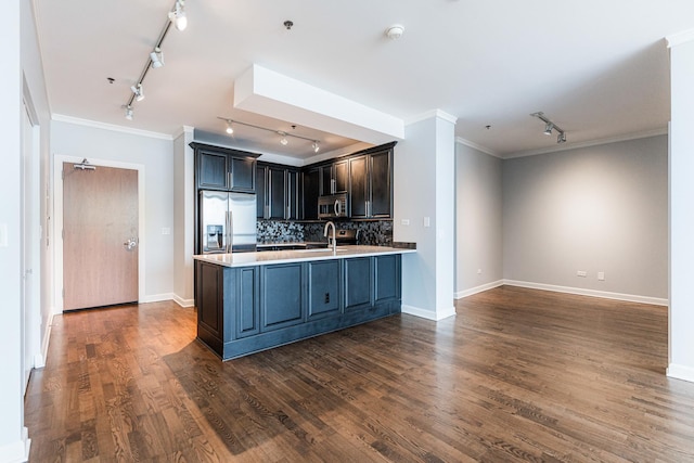 kitchen featuring appliances with stainless steel finishes, ornamental molding, dark hardwood / wood-style flooring, and decorative backsplash