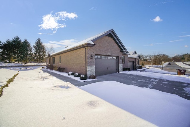 snow covered property featuring a garage