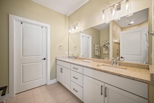 bathroom featuring tile patterned flooring, a shower, and vanity