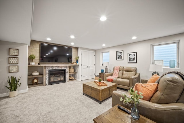 living room with a large fireplace and carpet flooring