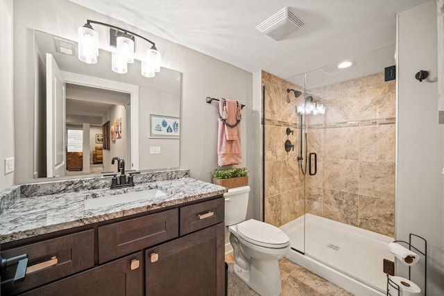 bathroom featuring toilet, an enclosed shower, and vanity