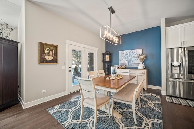 dining space featuring french doors, an inviting chandelier, and dark hardwood / wood-style floors