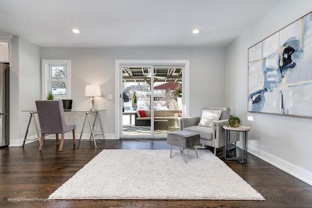 sitting room with dark hardwood / wood-style flooring and plenty of natural light