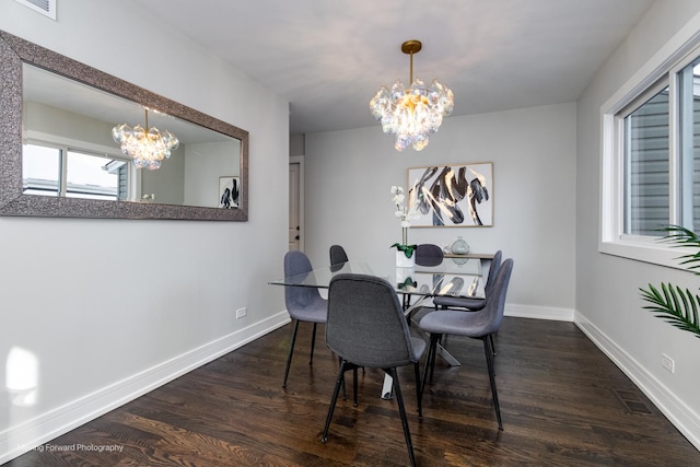 dining room featuring a notable chandelier and dark hardwood / wood-style floors