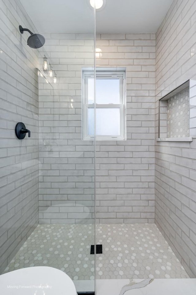 bathroom with toilet and an enclosed shower