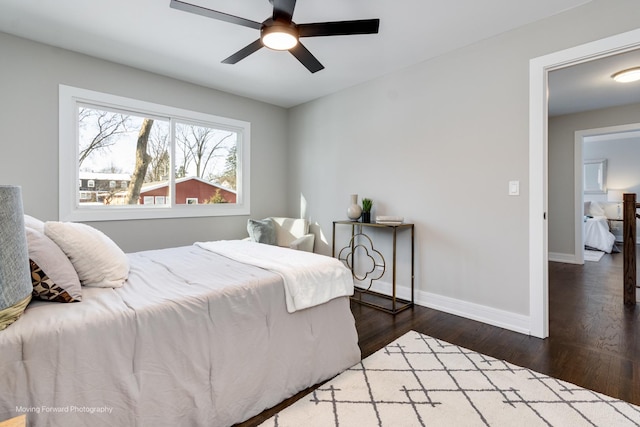 bedroom with ceiling fan and dark wood-type flooring