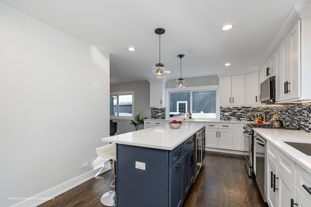 kitchen featuring white cabinetry, pendant lighting, and dark hardwood / wood-style floors