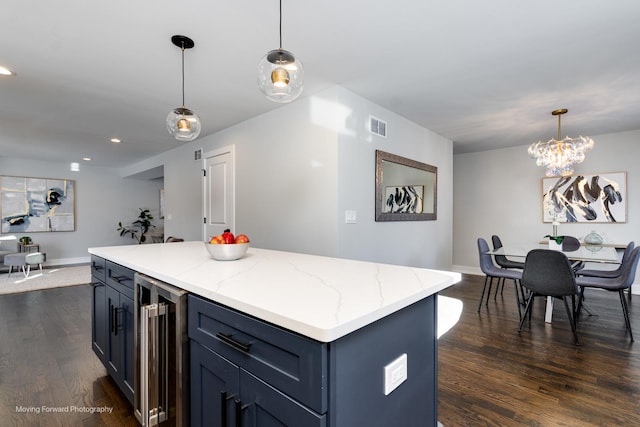 kitchen with a center island, beverage cooler, dark hardwood / wood-style flooring, and hanging light fixtures