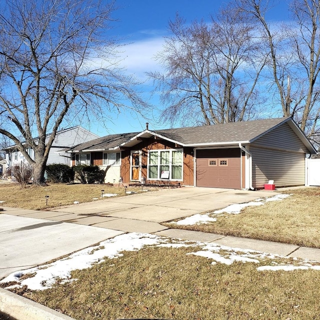 ranch-style house with a garage and a front lawn