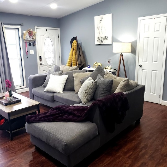 living room with a healthy amount of sunlight and dark hardwood / wood-style flooring