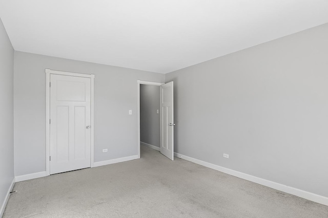 unfurnished bedroom featuring light carpet