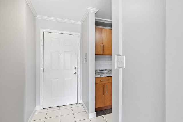 corridor featuring light tile patterned floors and ornamental molding