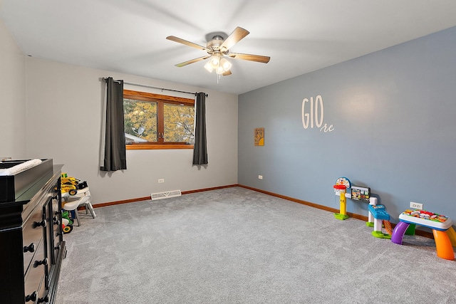 recreation room with ceiling fan and light colored carpet