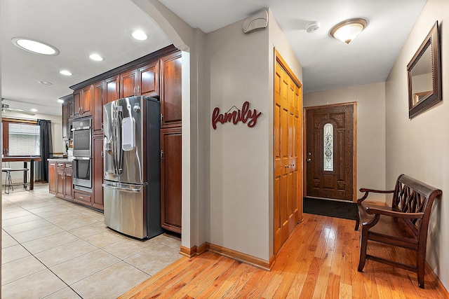 kitchen featuring appliances with stainless steel finishes and light hardwood / wood-style flooring